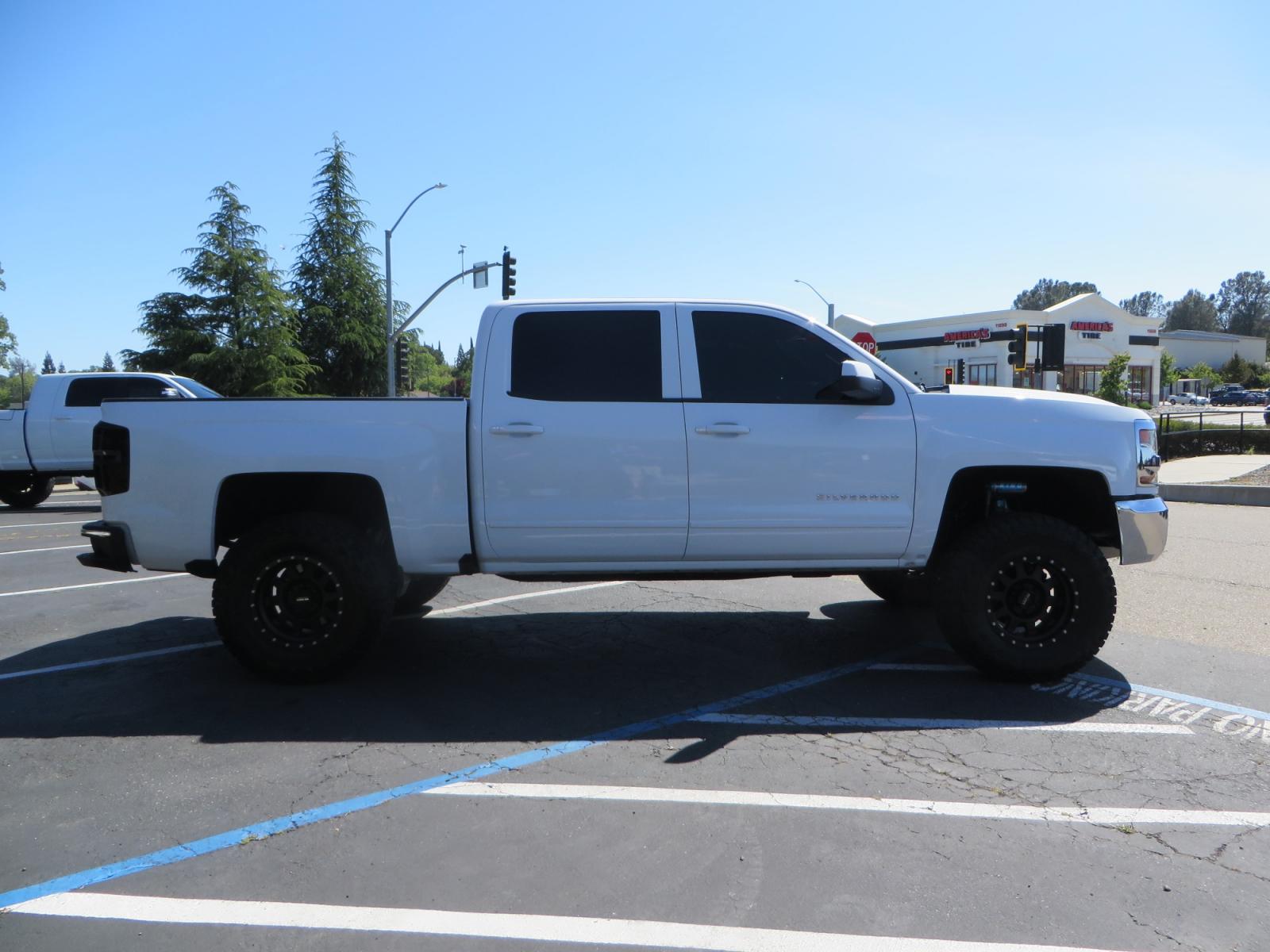 2018 White /BLACK Chevrolet Silverado 1500 LT (3GCPCREC7JG) with an 5.3L V8 OHV 16V engine, automatic transmission, located at 2630 Grass Valley Highway, Auburn, CA, 95603, (530) 508-5100, 38.937893, -121.095482 - Must see Pre Runner.... CST front lift spindals, Camburg UCA's, King Adjustable 2.5 Coil-overs, King 2.5 rear shocks, 35" Toyo RT Trail tires, 17" Method Race wheels, MZ front skid plate, G2 rear differntail cover, Full size bed mounted spare tire, Black Vinyl roof wrap, smoke tail lights and 3rd br - Photo #3